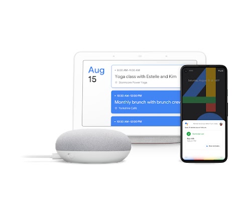 A Google Home, laptop, and phone featuring Hey Google